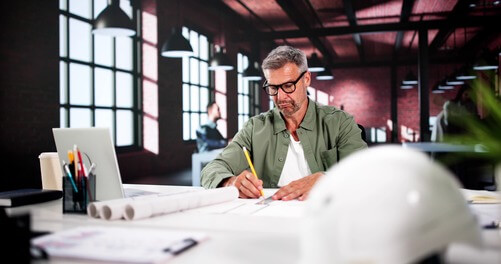 Civil engineer sitting at his desk doing work