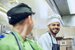 two chefs smiling at each other in the kitchen