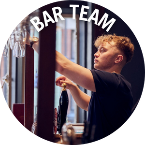 Bar team member putting glasses on shelf. Banner Reads 'Bar Team'