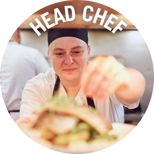 Head Chef adds garnish to dish in the kitchen. Banner reads 'Head Chef'