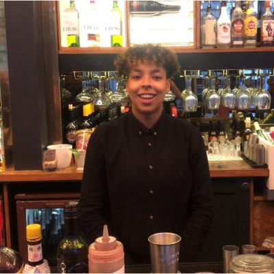 2 bartenders shaking cocktails behind bar