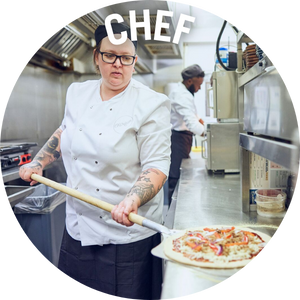 Chef lifts pizza using a pizza paddle. Link to Chef Jobs