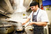 male chef cooking in a kitchen