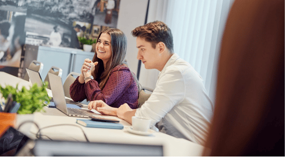 Two HR grads take part in a team meeting