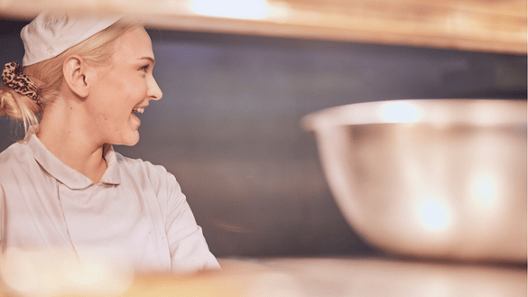 A chef apprentice works in a kitchen at a Harvester