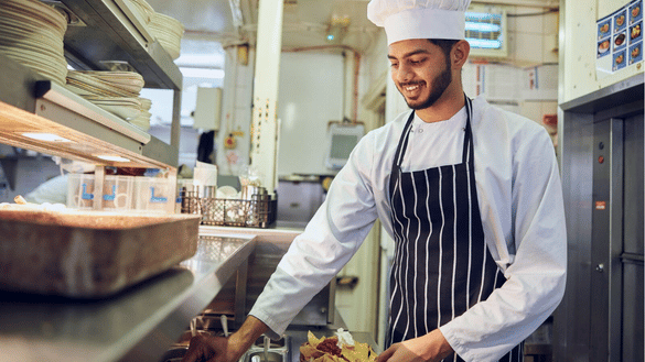 A chef apprentice works in a Nicholson's kitchen