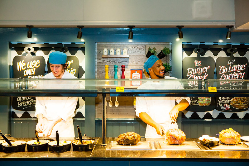 steel pans hanging up in commercial kitchen