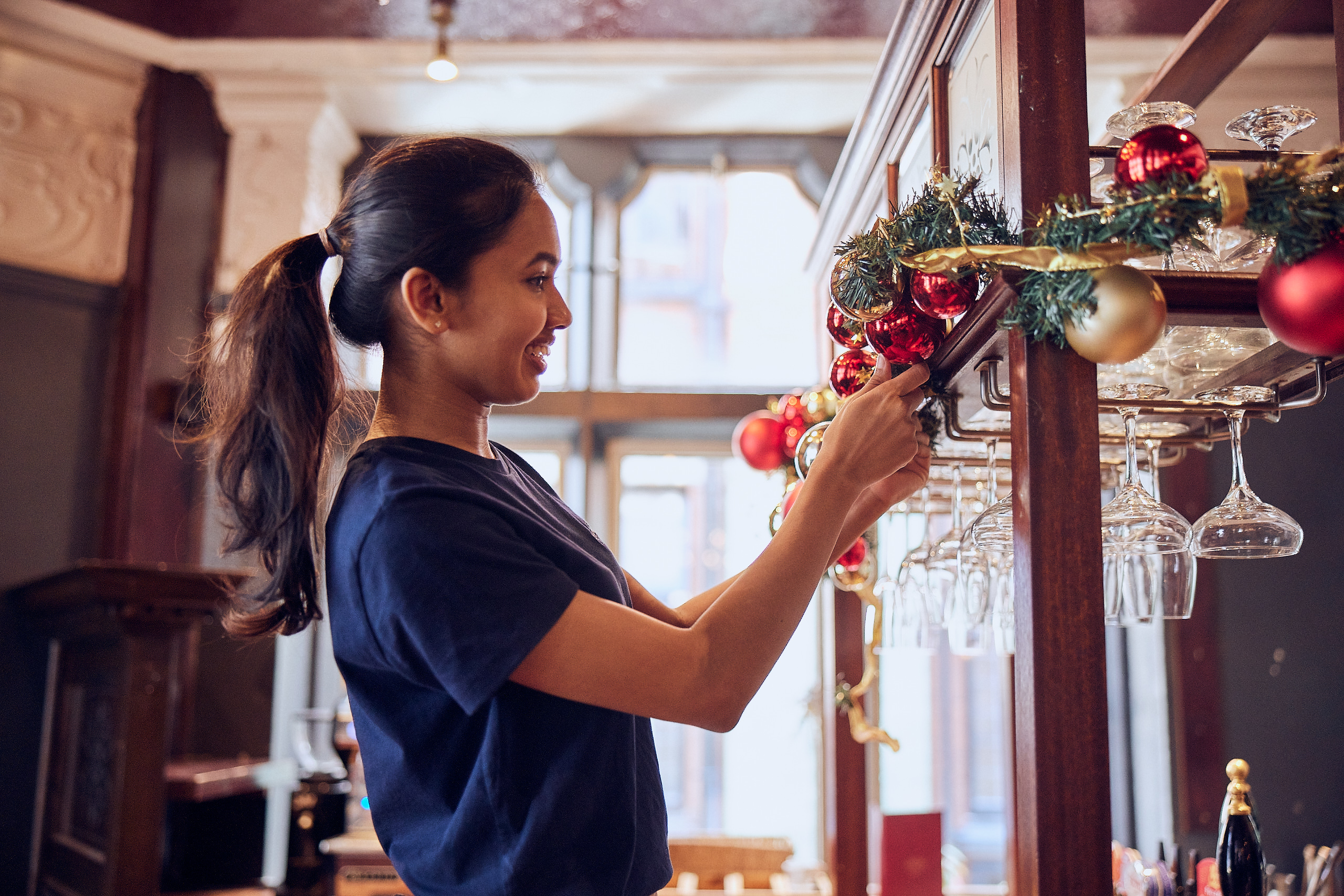 Two Barr staff decorating bar