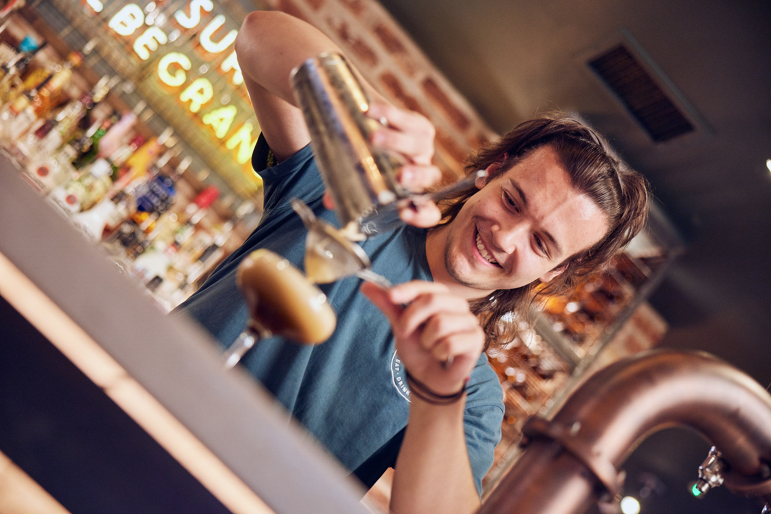 Bar staff pouring cocktail 