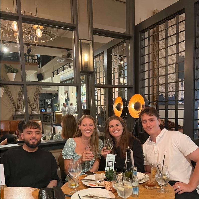 three people sitting at a table laughing