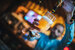 Bar staff filling glass with beer. Barmen is pouring lager beer to glass from beer taps.