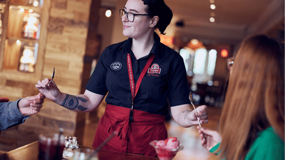 Waiting team member at Toby Carvery serves guests