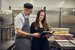 man and woman wearing chef uniform smiling at each other