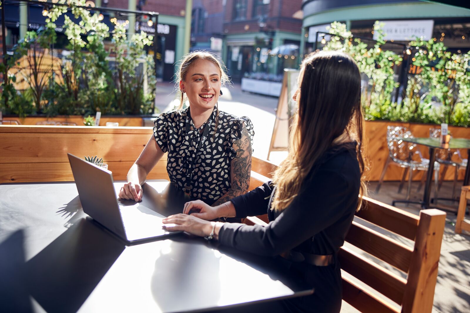 m&b operations graduate smiling at computer