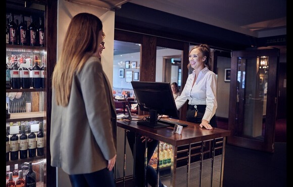 image of team leader greeting guests