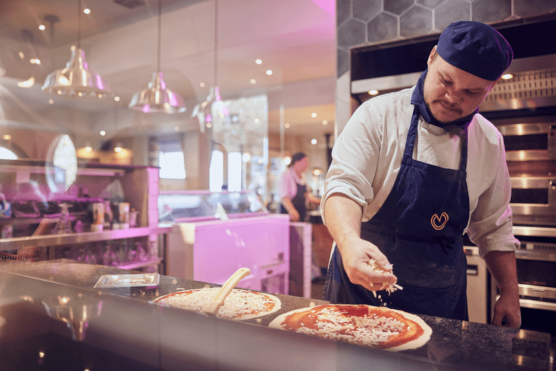 image of stonehouse kitchen crew making pizzas in the kitchen