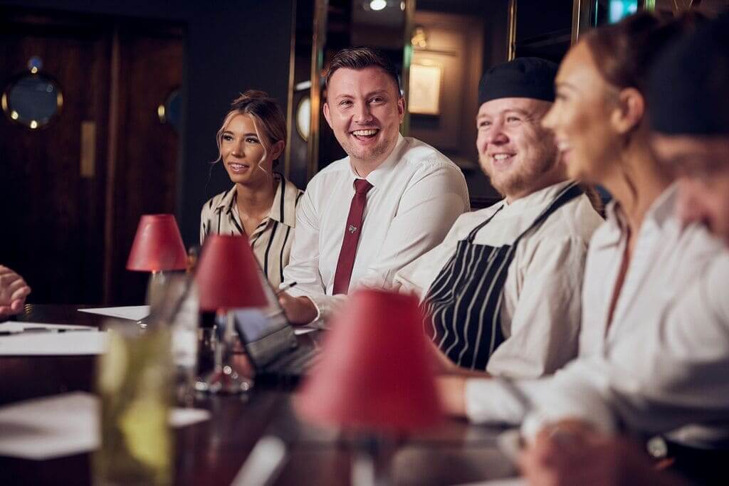 management staff having a meeting and smiling