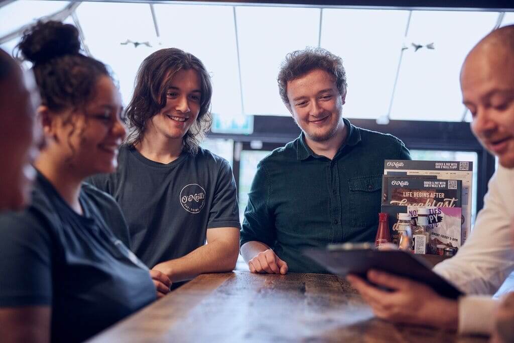 manager supporting teammates in pub