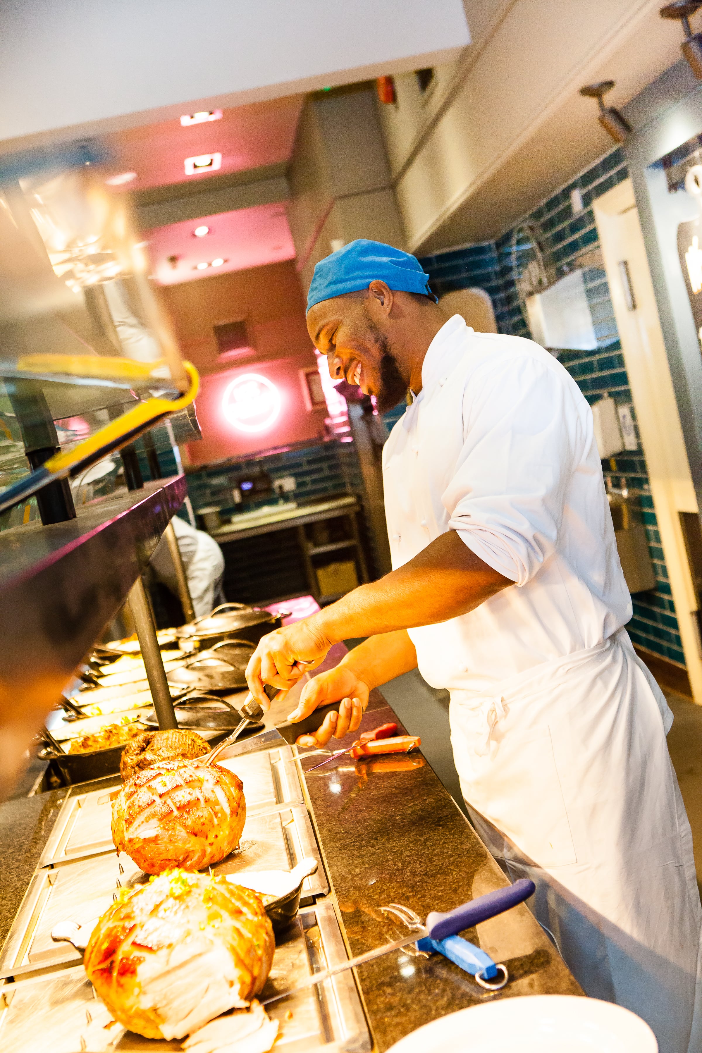 chef plating food to pass to waiting staff