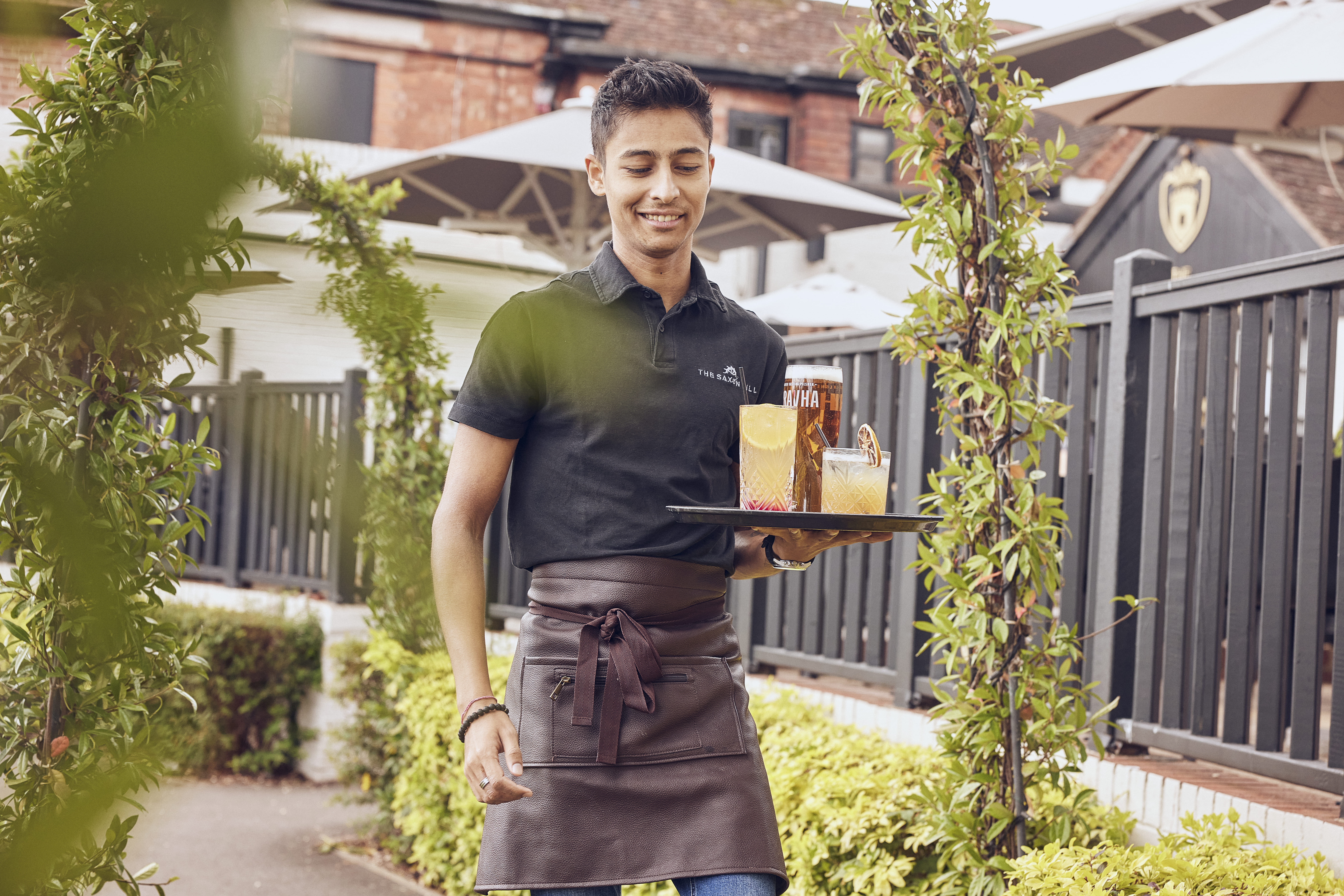 image of part-time staff holding drinks tray 