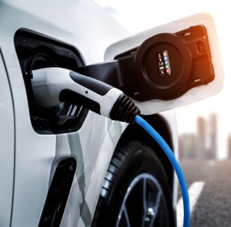 electric vehicle charger plugged into a car