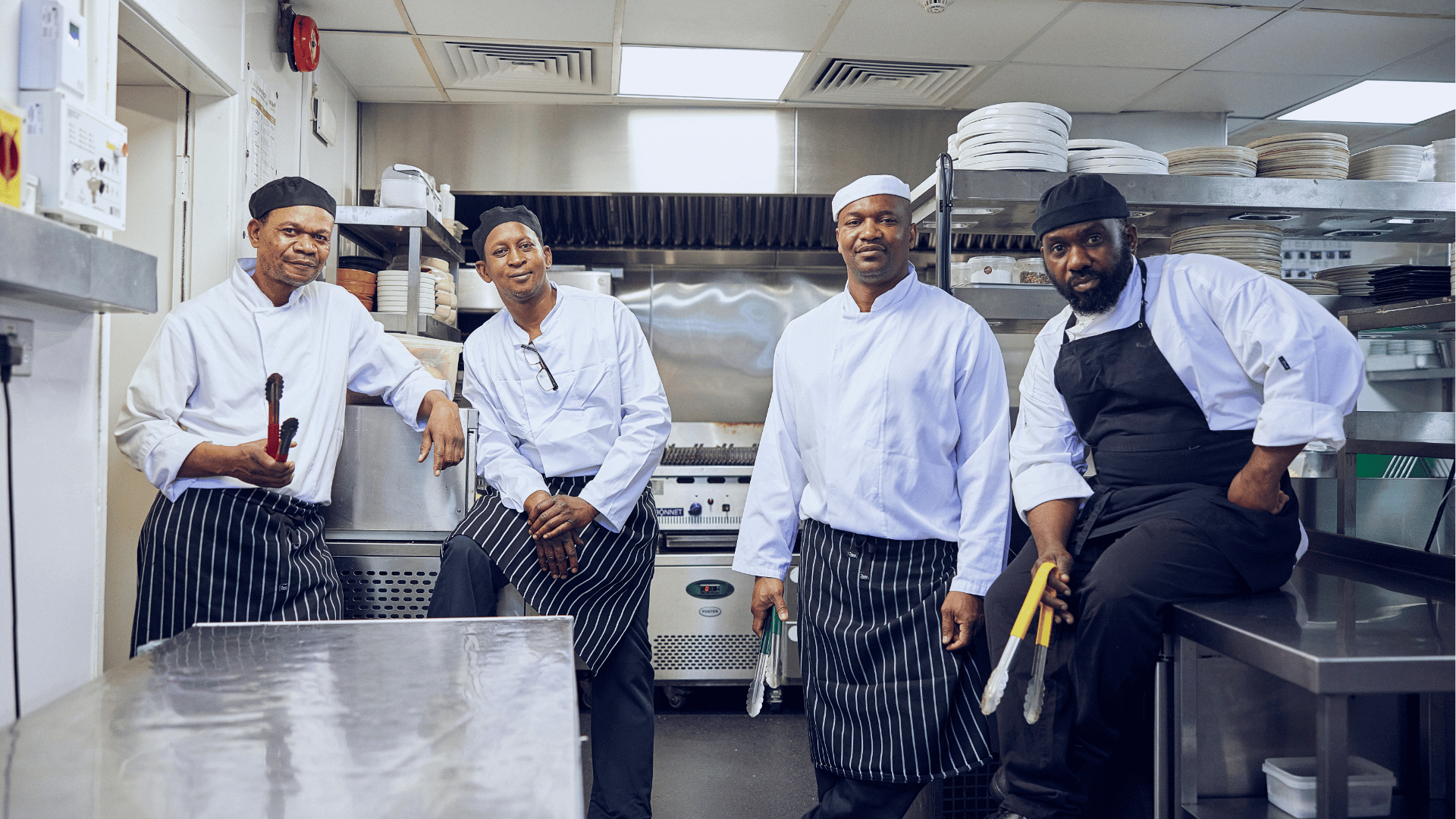 steel pots and pans hanging vertically in a commercial kitchen