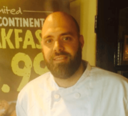steel pans hanging up in commercial kitchen