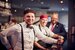 three m&B employees posing for a photo behind the bar