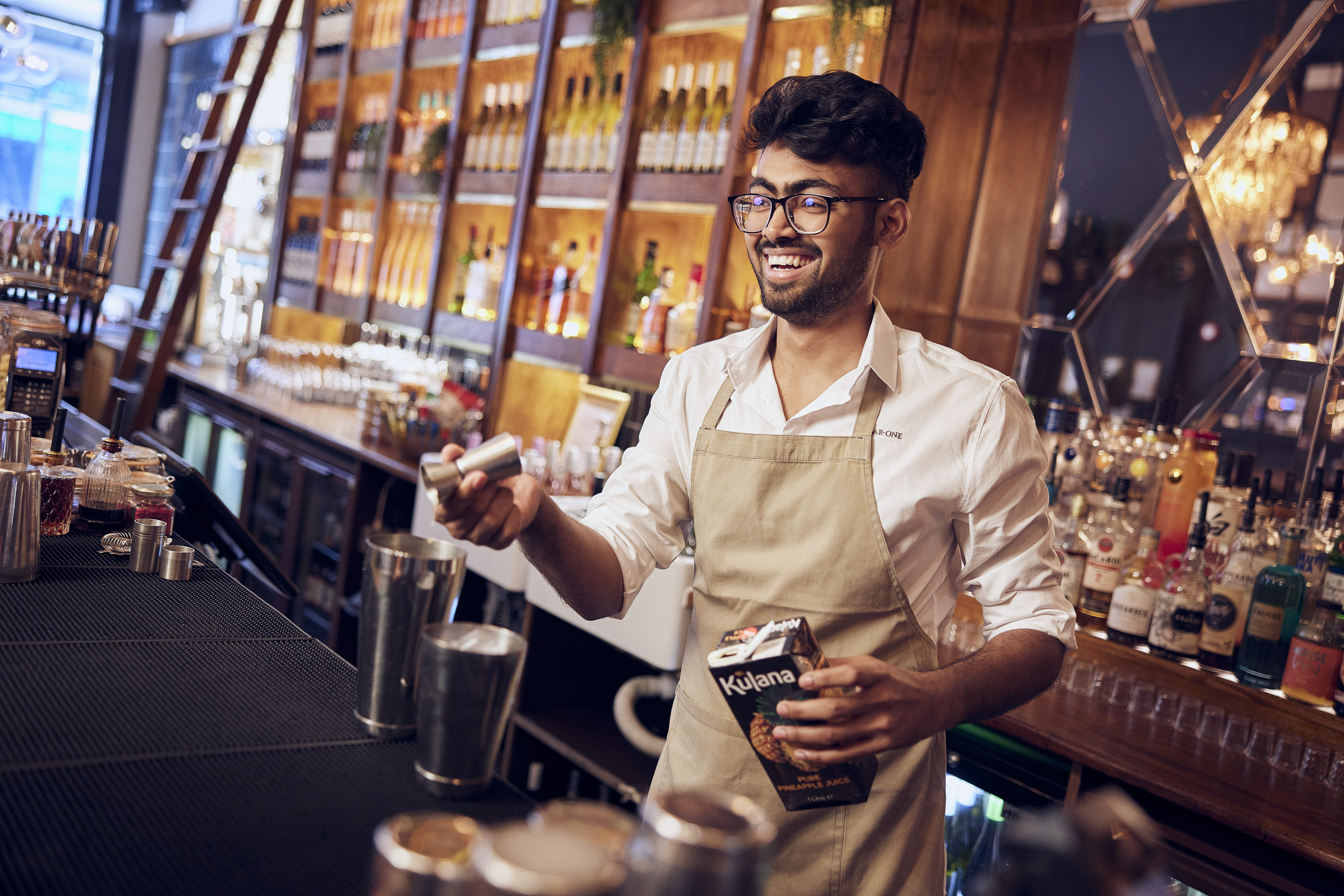 bar staff mixing cocktails in a bar