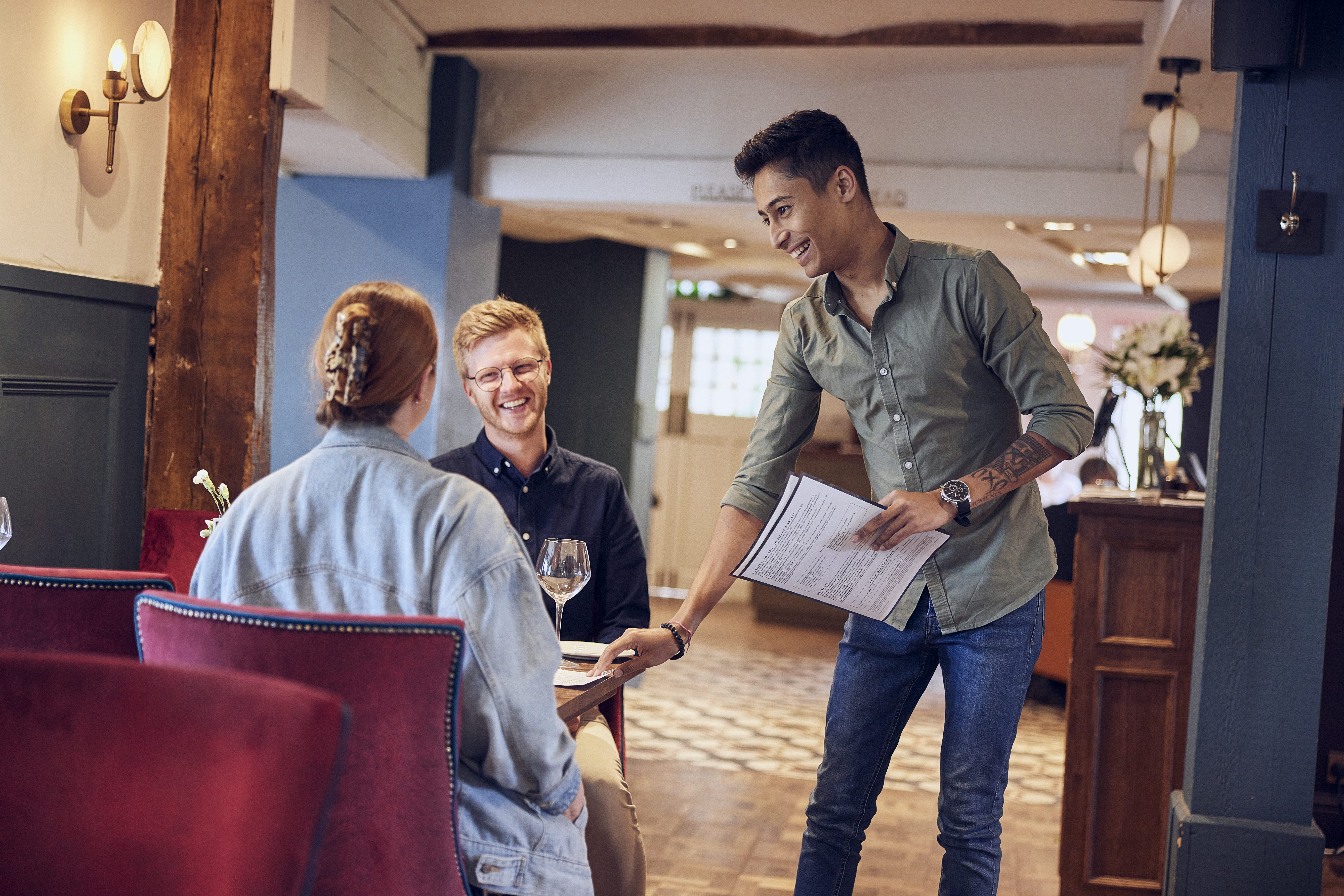 team leader smiling at customers in pub