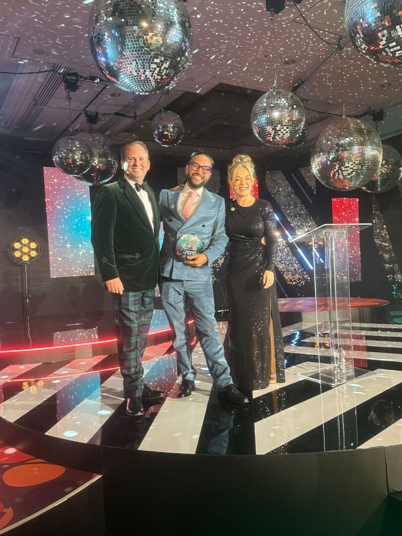 General Manager of the year awards - three people smiling on stage