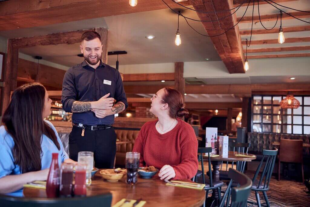 waiting staff greeting guests at M&B - customer service in hospitality