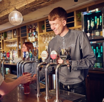 young bartender serving a customer