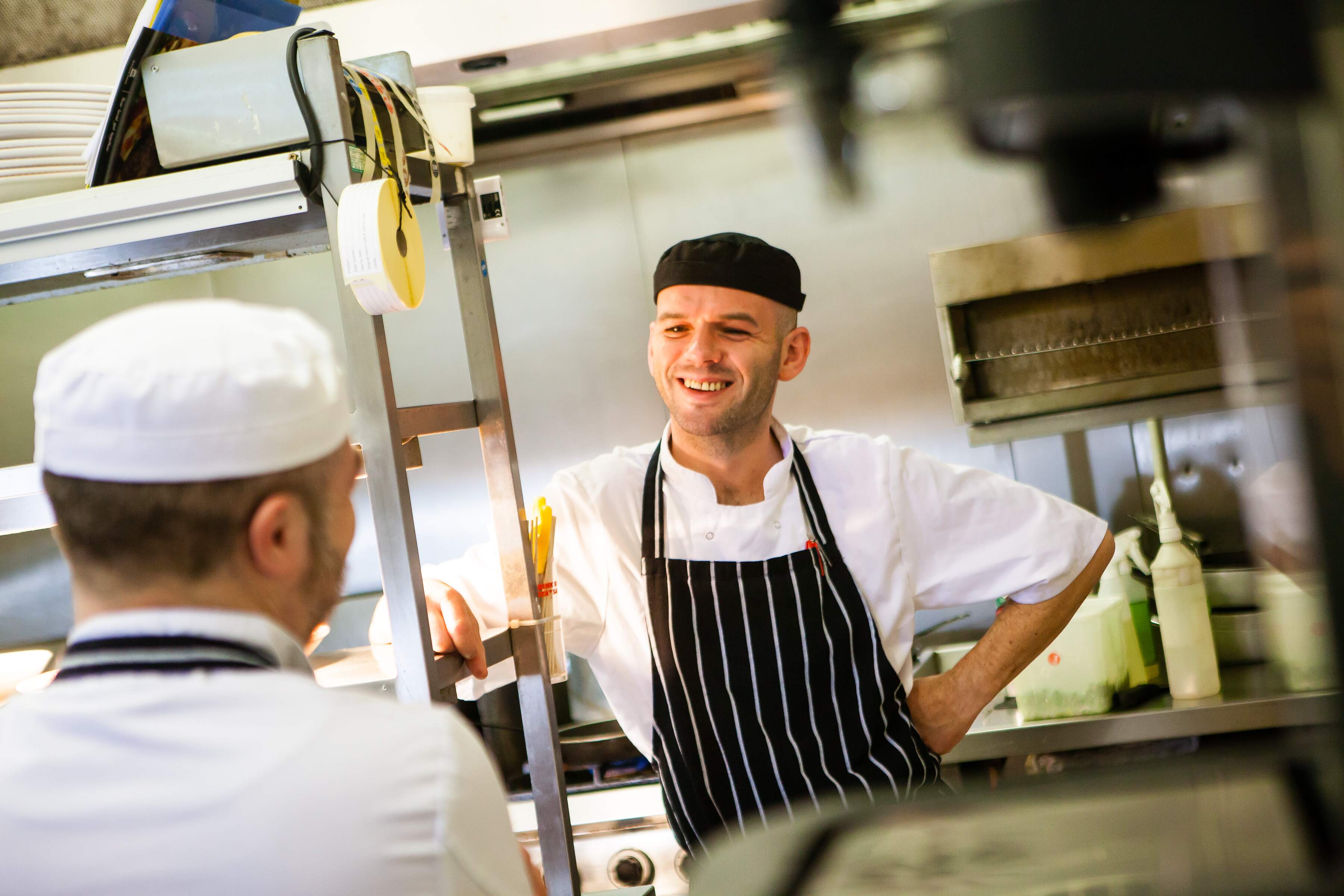 image of chef smiling in kitchen 