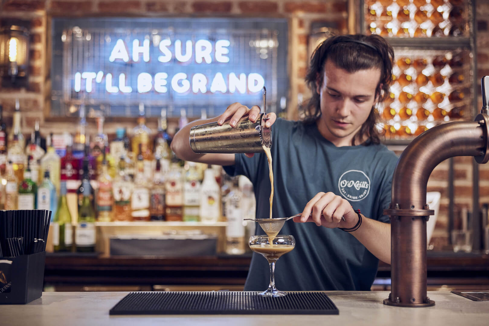 university student pouring a drink at o'neills