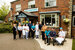 line of people standing outside a restaurant in their chef whites and staff uniforms
