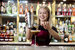 image of pesto bartender pouring a drink with a smile 