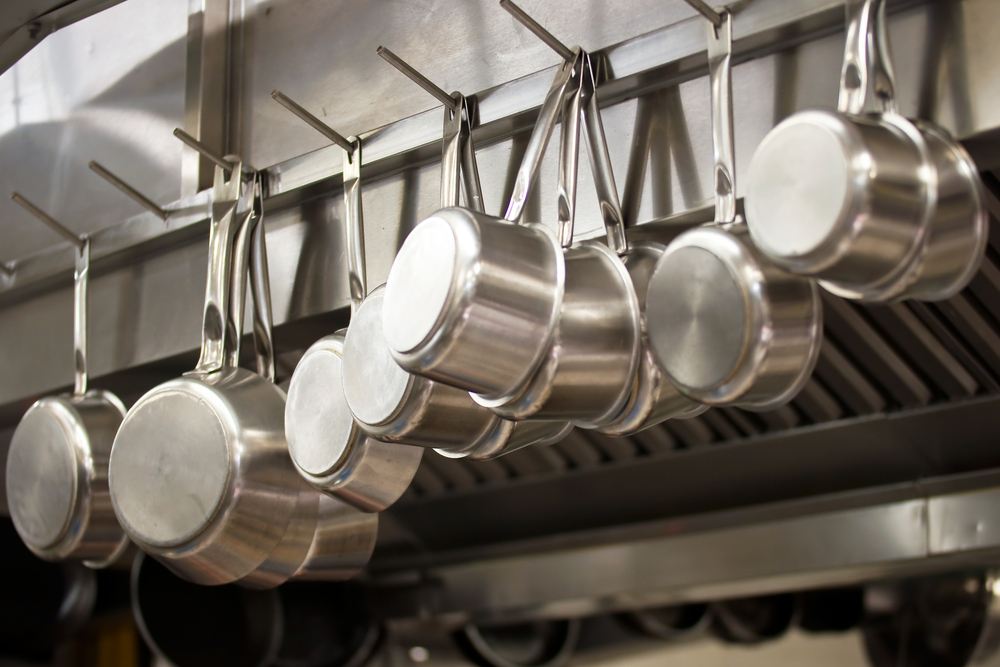 steel pans hanging in commercial kitchen