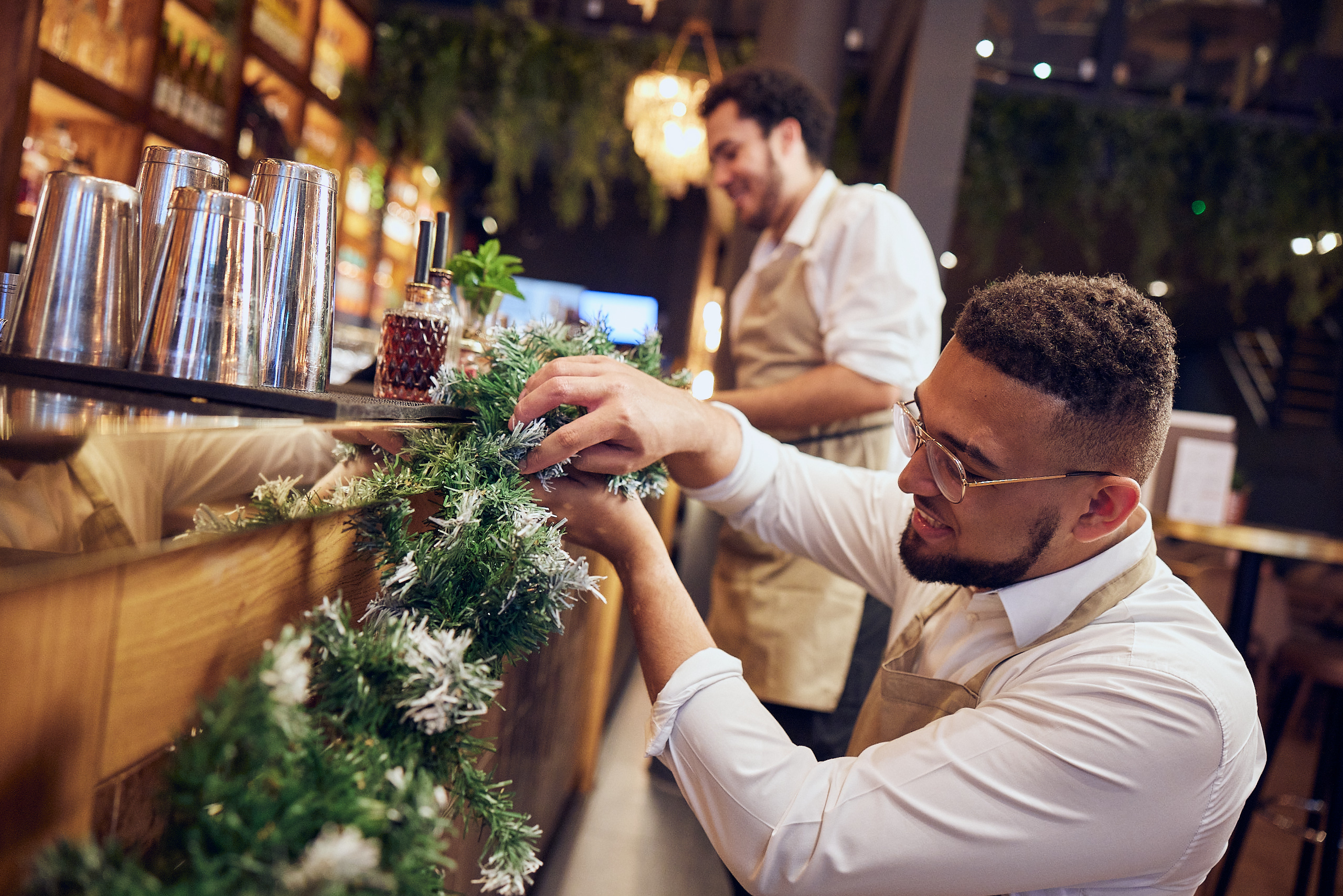 Two Barr staff decorating bar