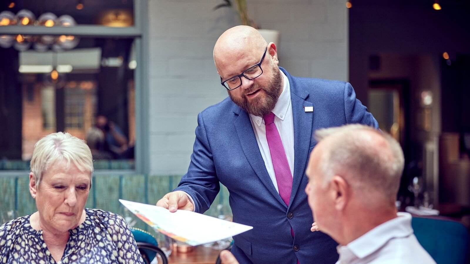 image of manager serving guests at a pub 