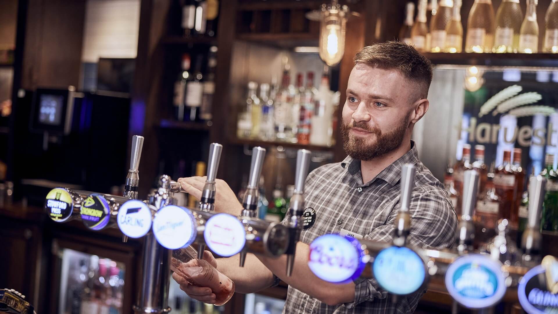 image of front of house staff pouring a drink 