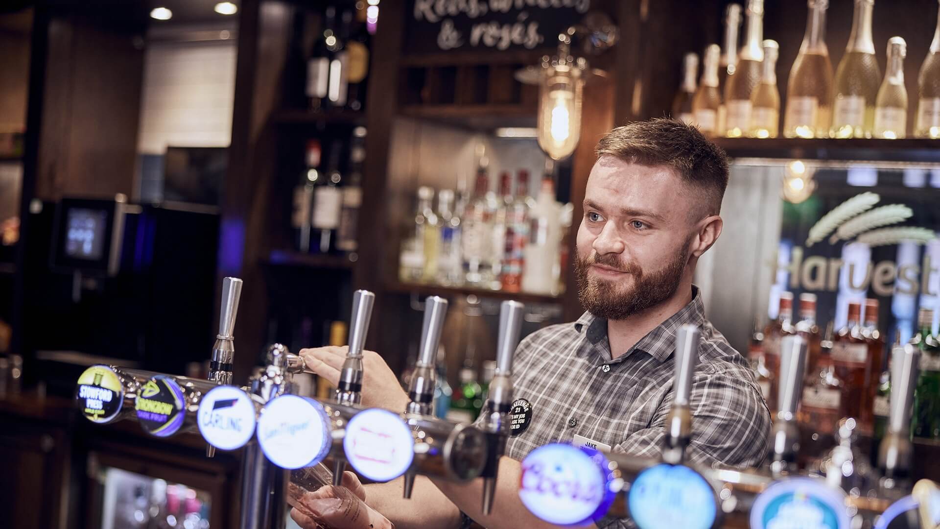 pub manager serving drinks