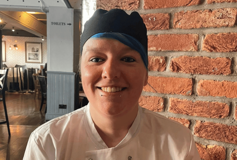 steel pans hanging up in commercial kitchen