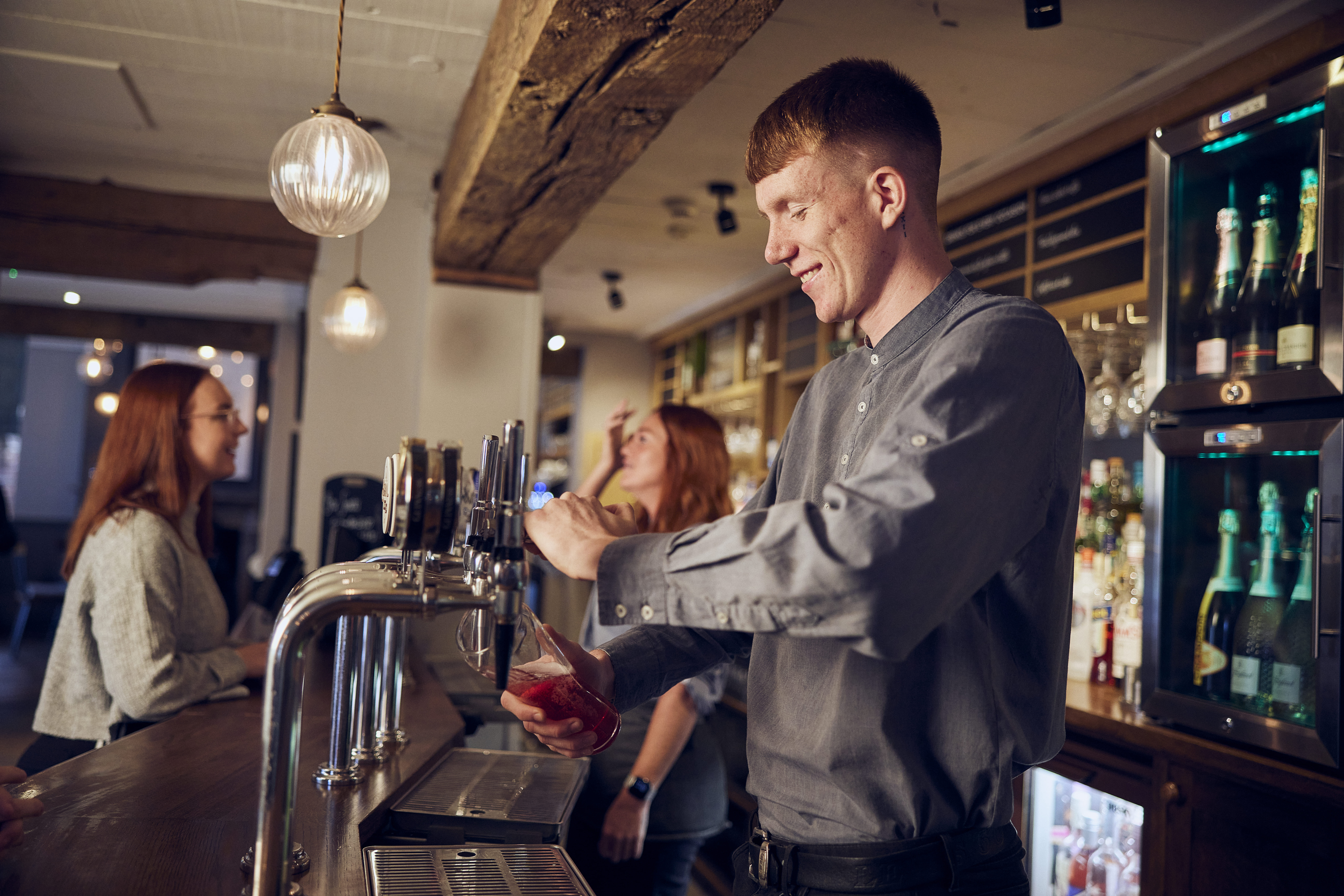 image of man pouring a pint at vintage inns m&b