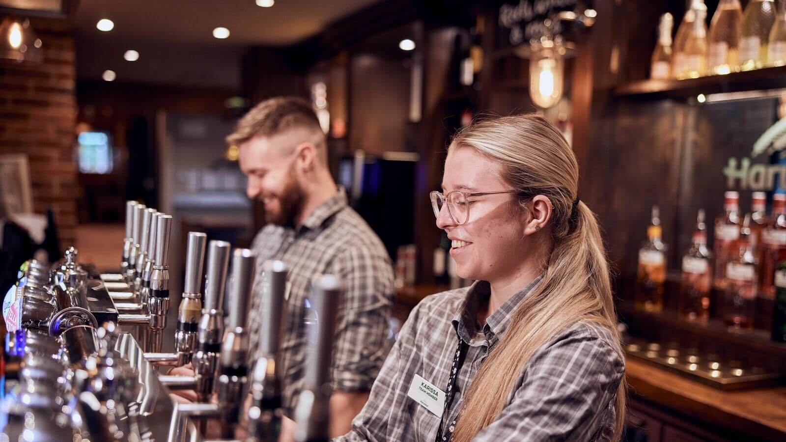 image of bar staff pouring drinks 