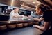 image of ego employees in the kitchen passing plate of food 