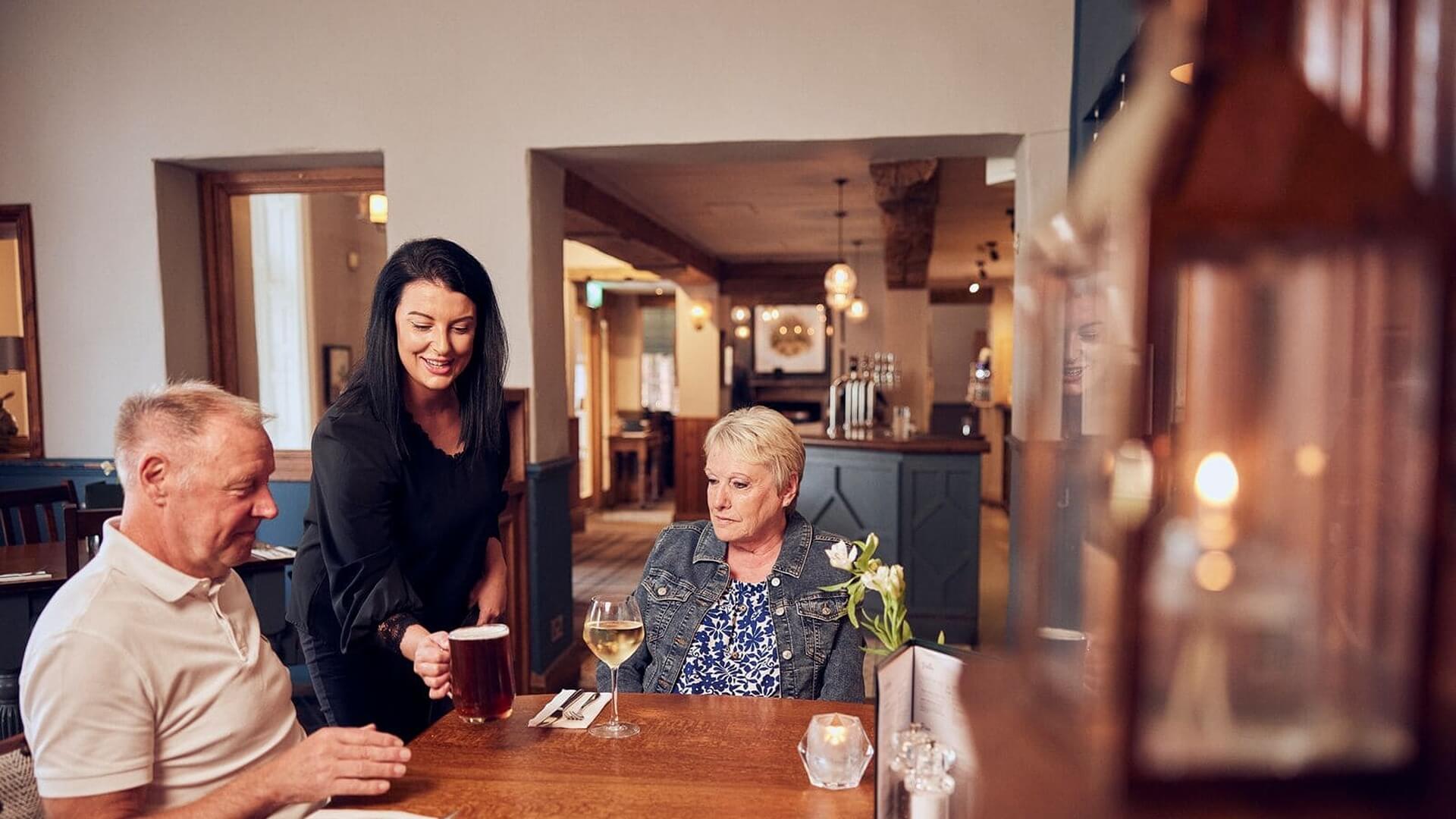 image of general manager serving guests 