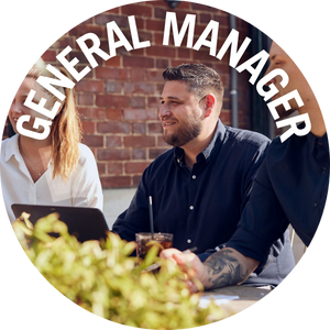 General Manager surrounded by team, having a meeting in the pub garden