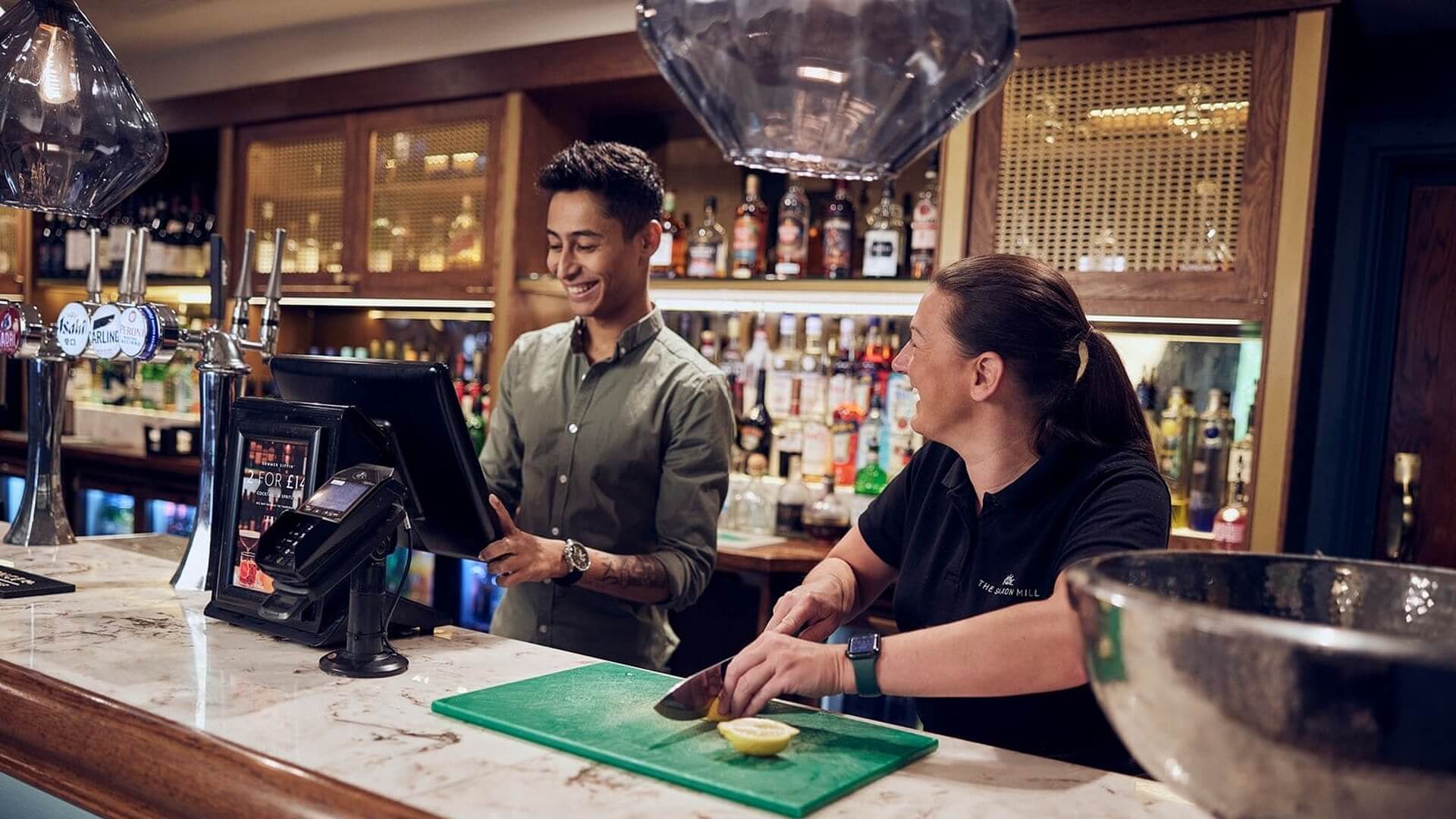 manchester M&B employees behind bar working