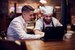 image of head chef in interview looking at laptop with manager